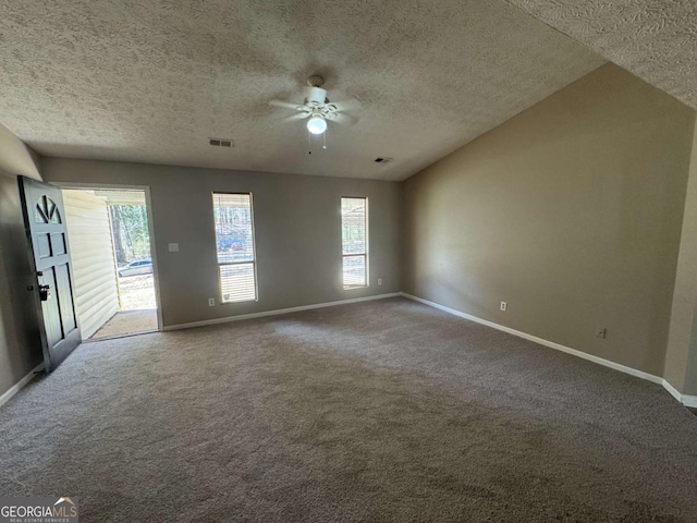 carpeted empty room featuring visible vents, a textured ceiling, a ceiling fan, and baseboards