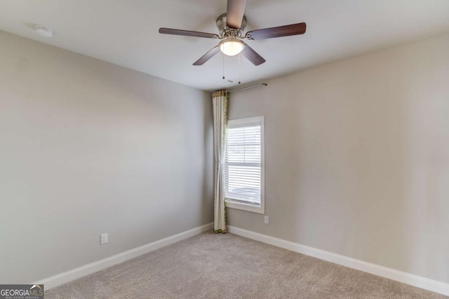 empty room featuring ceiling fan, visible vents, baseboards, and light colored carpet