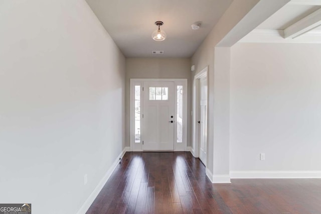 entryway with dark wood-style flooring, visible vents, and baseboards