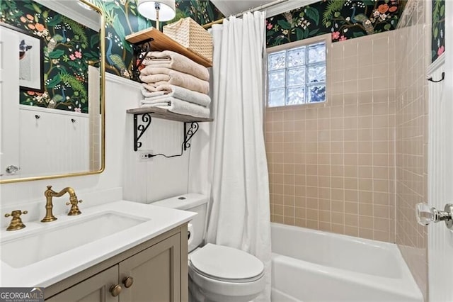 bathroom with toilet, wallpapered walls, shower / bath combo, and vanity