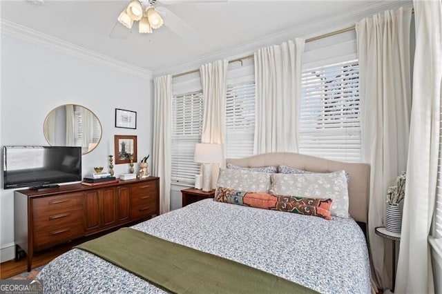 bedroom featuring ceiling fan, crown molding, and wood finished floors