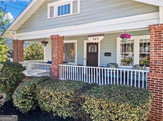 view of front of property with covered porch and brick siding