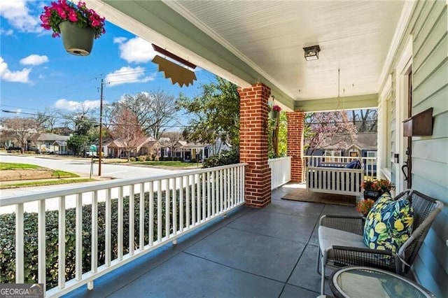 balcony featuring covered porch and a residential view