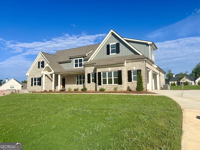 view of front of home featuring central AC unit, brick siding, driveway, board and batten siding, and a front yard