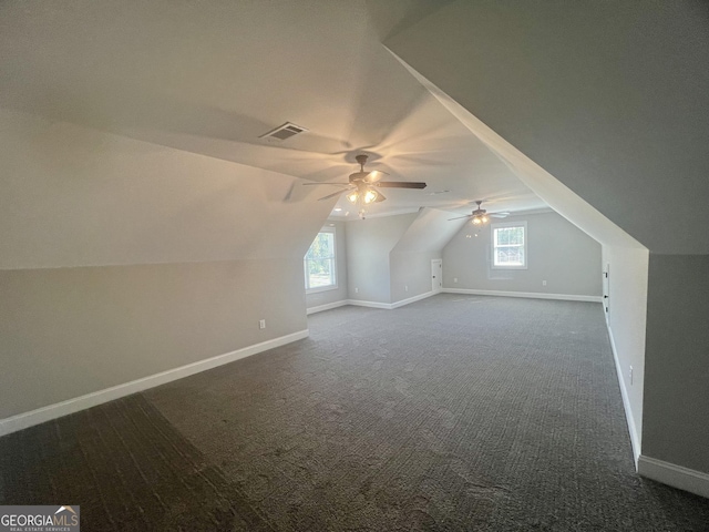 additional living space with baseboards, visible vents, and a healthy amount of sunlight