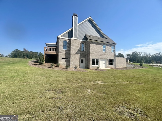 back of property with brick siding, a lawn, and a chimney