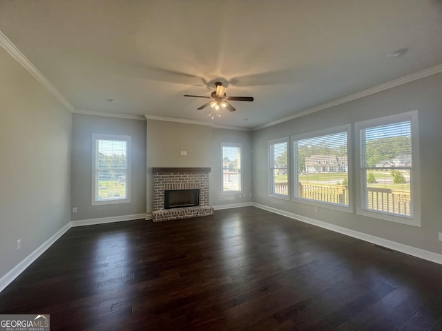 unfurnished living room featuring dark wood-type flooring, a wealth of natural light, and baseboards