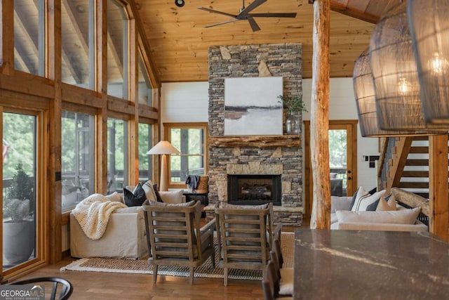 living room with high vaulted ceiling, a fireplace, wood finished floors, wood ceiling, and a ceiling fan