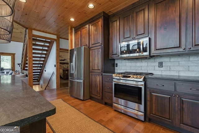 kitchen featuring wooden ceiling, stainless steel appliances, dark brown cabinets, light wood-type flooring, and decorative backsplash