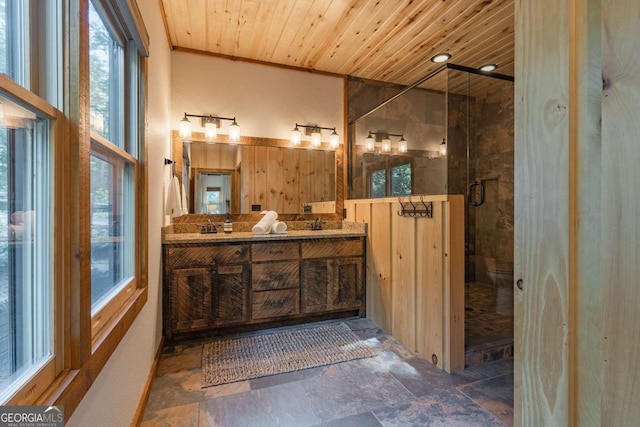 bathroom featuring stone finish flooring, double vanity, a stall shower, and wooden ceiling