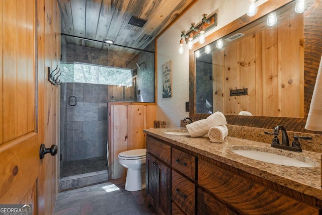 bathroom featuring a sink, toilet, and a shower stall