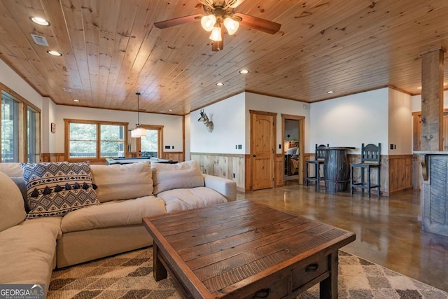 living room featuring a wainscoted wall, wood ceiling, finished concrete floors, and recessed lighting