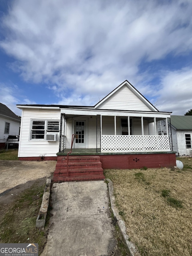 view of front of home with cooling unit and covered porch