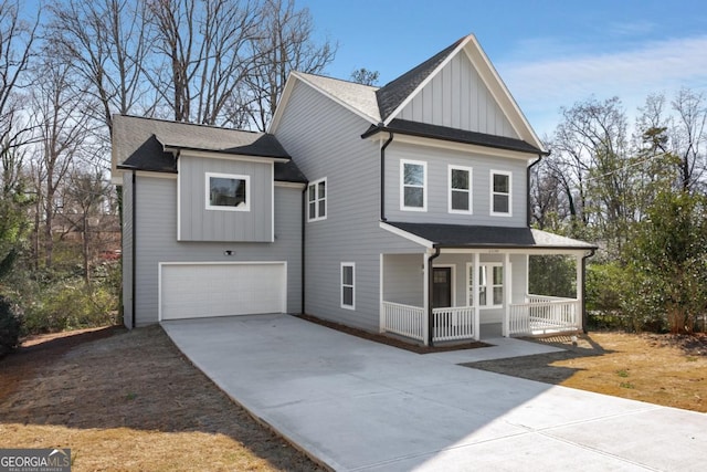 view of front facade with a garage, covered porch, board and batten siding, and concrete driveway