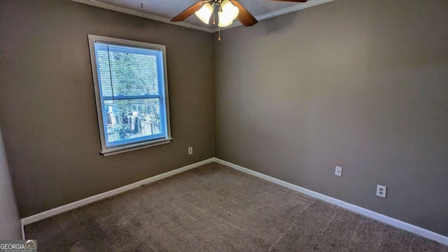 carpeted spare room featuring a ceiling fan, ornamental molding, and baseboards