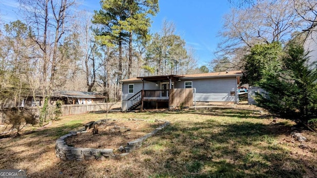 back of house featuring a yard, stairs, fence, and a wooden deck