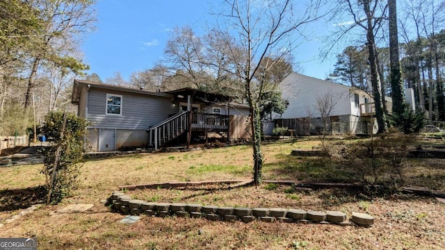 back of house with a deck, a yard, and stairway