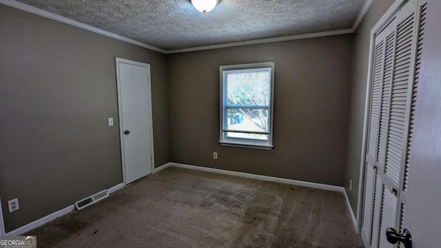 unfurnished bedroom featuring carpet floors, ornamental molding, visible vents, and baseboards