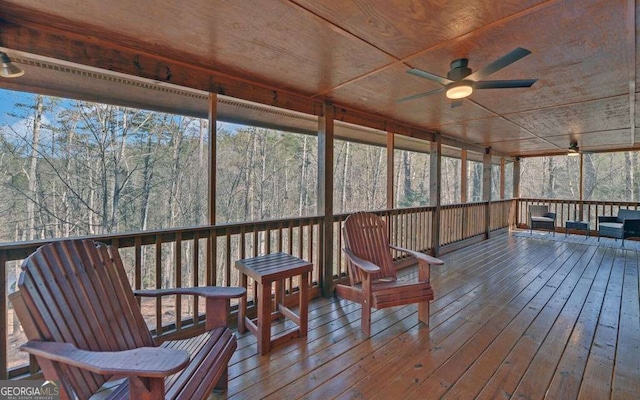 sunroom / solarium with a healthy amount of sunlight and a ceiling fan