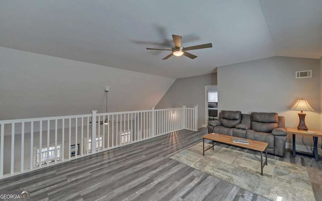 interior space with visible vents, wood finished floors, a ceiling fan, and vaulted ceiling