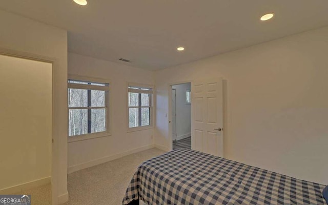 carpeted bedroom with recessed lighting, visible vents, and baseboards