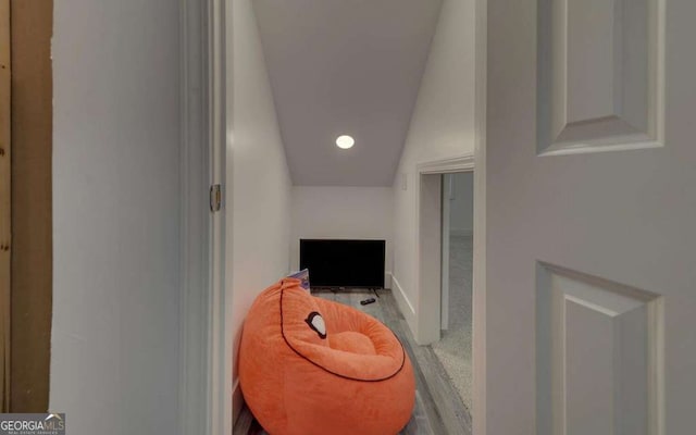 hallway featuring recessed lighting and vaulted ceiling