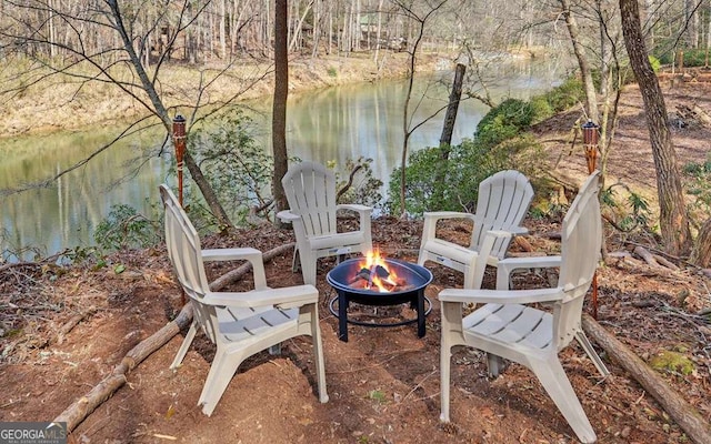 view of patio featuring a water view and a fire pit