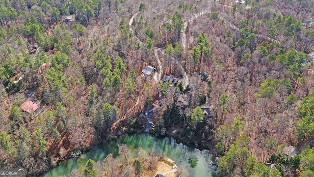 birds eye view of property with a view of trees