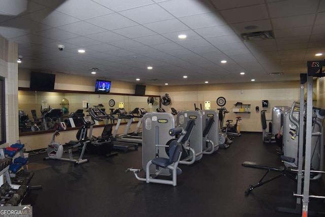 exercise room with a drop ceiling and visible vents