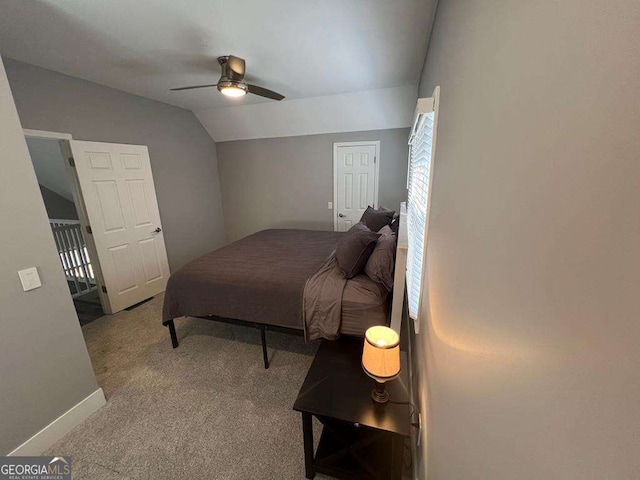 bedroom with baseboards, a ceiling fan, carpet flooring, and vaulted ceiling