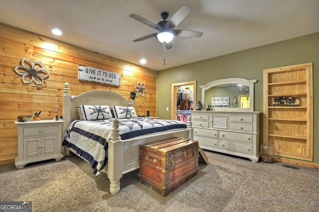 bedroom with a walk in closet, recessed lighting, visible vents, carpet flooring, and ceiling fan