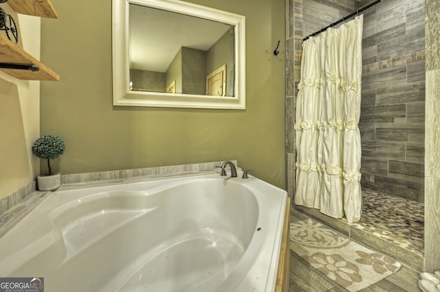 full bathroom with a stall shower and a bath
