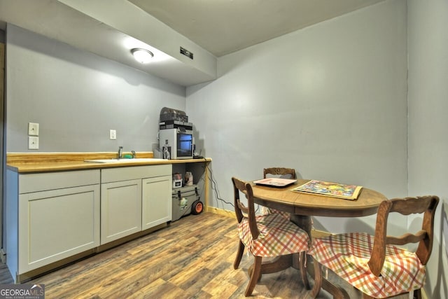 kitchen with wood finished floors and a sink