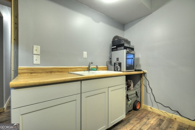 interior space featuring a sink and wood finished floors