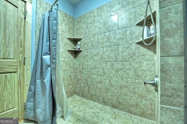 bathroom with tiled shower