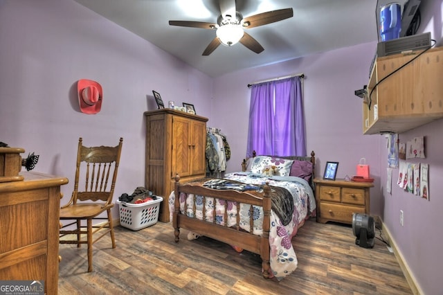 bedroom featuring baseboards and wood finished floors