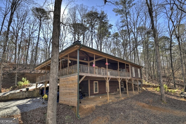 rear view of property with driveway and a deck