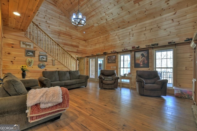 living room with stairway, wooden ceiling, hardwood / wood-style flooring, and wooden walls
