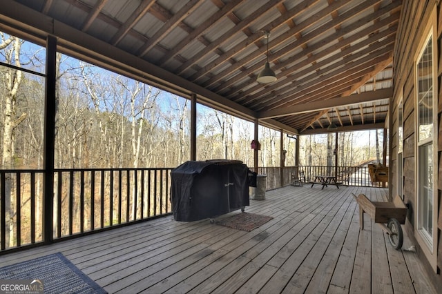 deck featuring a grill and a view of trees