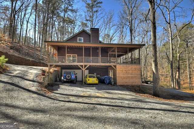 view of front of house with driveway and a chimney