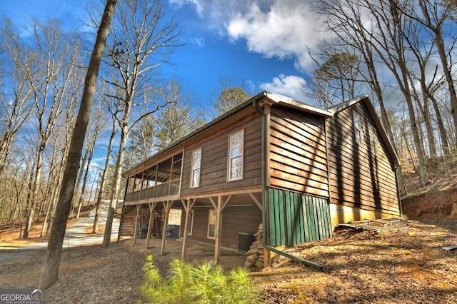 view of side of property with a sunroom and central AC