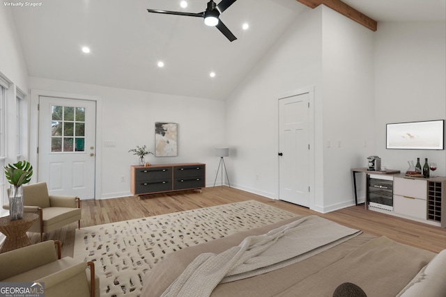 living room featuring light wood-style floors, beverage cooler, high vaulted ceiling, and beamed ceiling