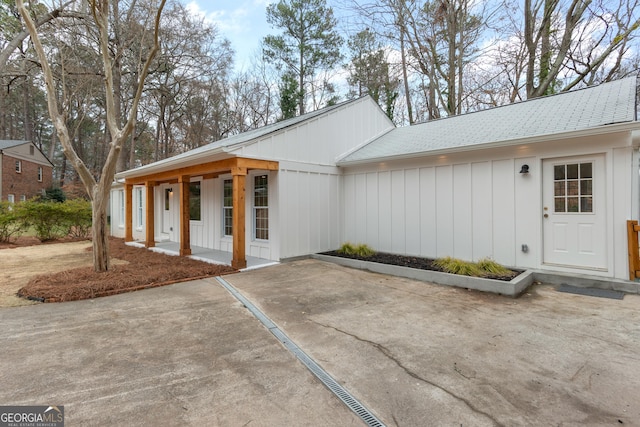 entrance to property with a porch and board and batten siding