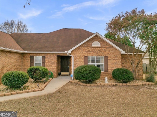 single story home with brick siding and a shingled roof