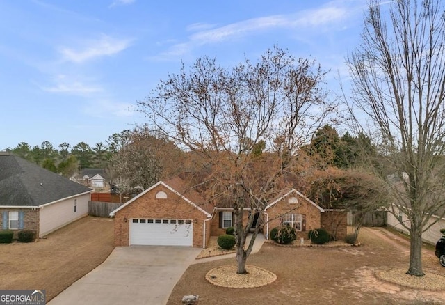 ranch-style house with concrete driveway, brick siding, fence, and an attached garage