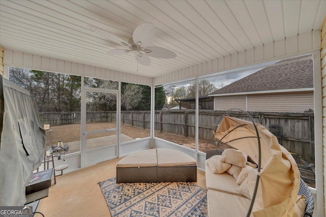 sunroom / solarium with a healthy amount of sunlight and a ceiling fan