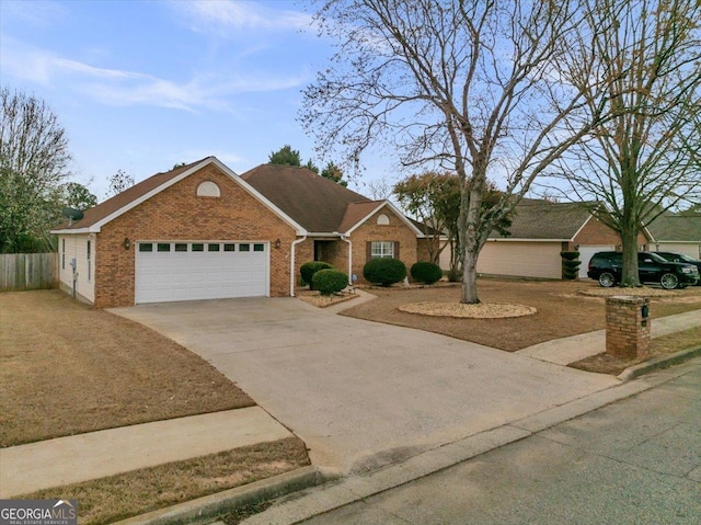 ranch-style home featuring driveway, an attached garage, fence, and brick siding