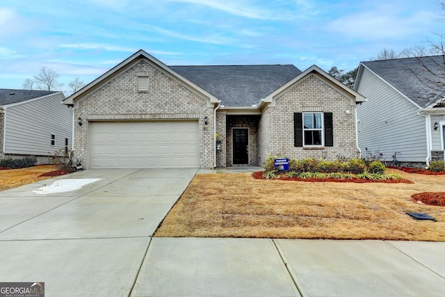 ranch-style house featuring a garage, a shingled roof, concrete driveway, and brick siding