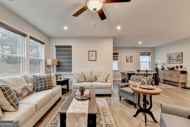 living room featuring recessed lighting, a ceiling fan, and light wood-style floors