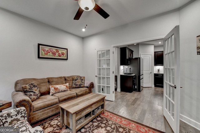 living room with a ceiling fan, recessed lighting, french doors, and light wood-style flooring